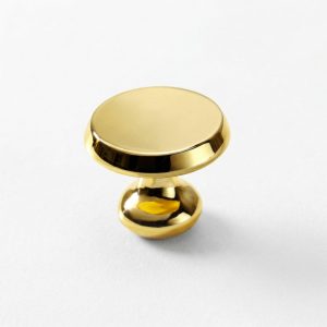 Botón de mueble circular plano en acabado bronce modelo Huaraz para cajones y puertas.